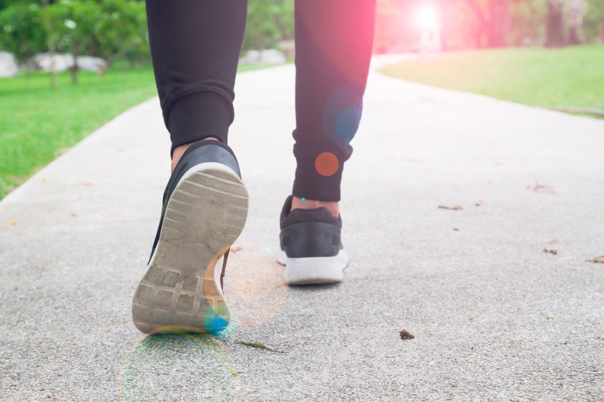 A woman moving forward on an outdoor path